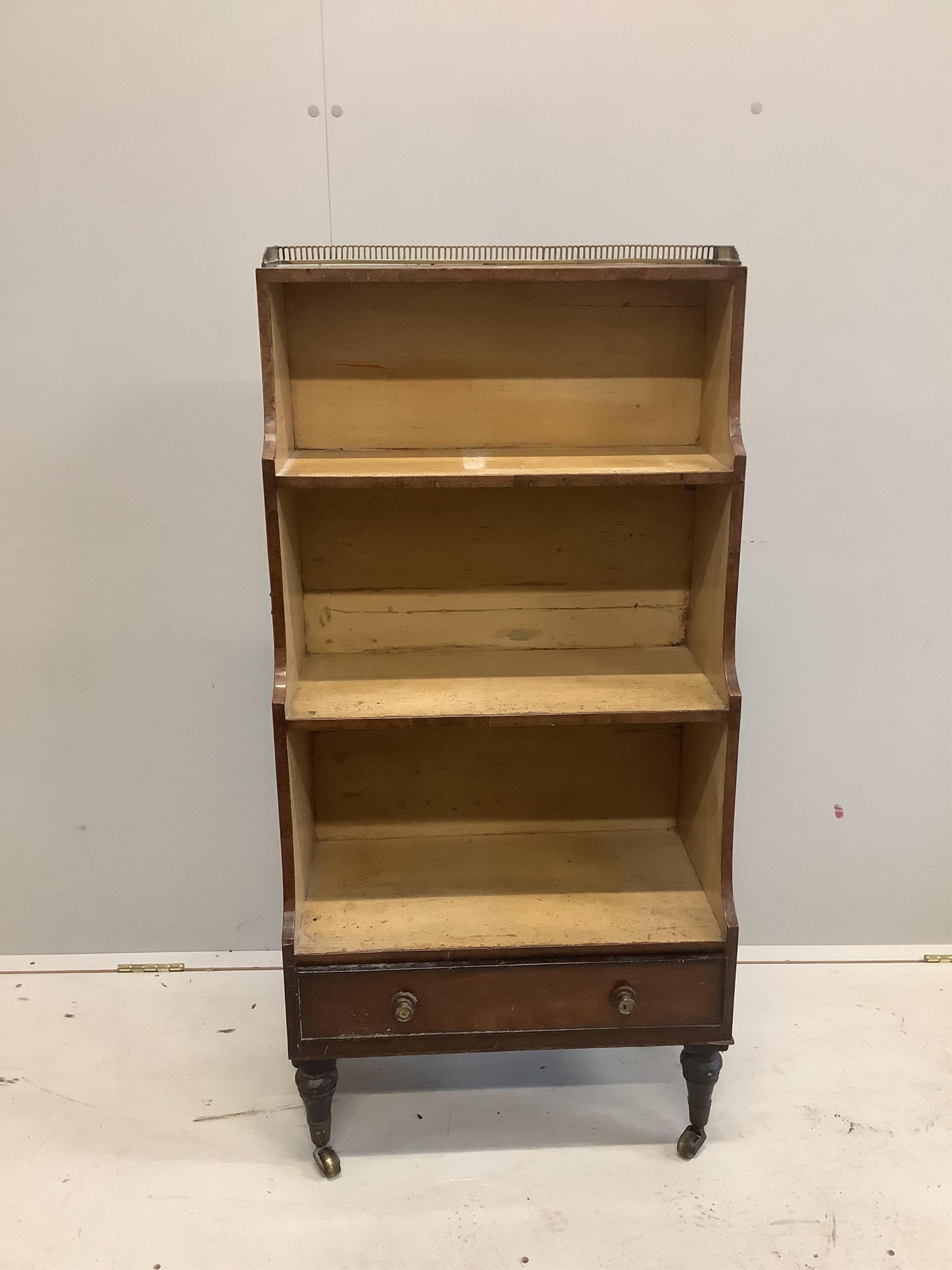 A Regency mahogany dwarf open bookcase, with three quarter brass gallery, width 56cm, depth 30cm, height 115cm. Condition - poor to fair